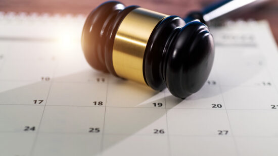 Wooden judge gavel on calendar